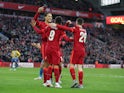 Liverpool's Roberto Firmino celebrates scoring their third goal with Virgil van Dijk and Andrew Robertson on January 9, 2022