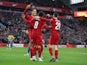 Liverpool's Roberto Firmino celebrates scoring their third goal with Virgil van Dijk and Andrew Robertson on January 9, 2022