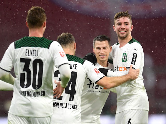 Borussia Monchengladbach's Stefan Lainer celebrates scoring their second goal with teammates on January 7, 2022