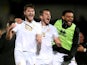 Port Vale's Brad Walker, Ben Garrity and Ryan Johnson celebrate after their FA Cup second round win against Burton Albion on December 4, 2021