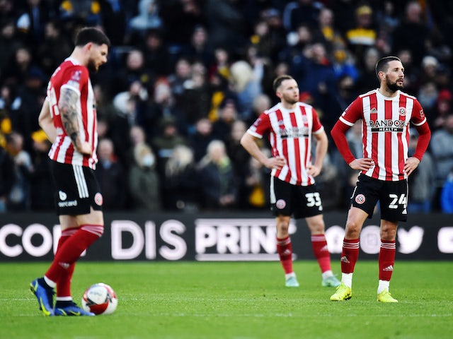 Sheffield United's Conor Hourihane with teammates look dejected after Wolverhampton Wanderers' Daniel Podence scores their third goal on January 9, 2022