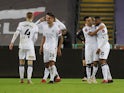 Swansea City's Olivier Ntcham celebrates with teammates after Southampton's Jan Bednarek scores an own goal and Swansea City's second on January 8, 2022