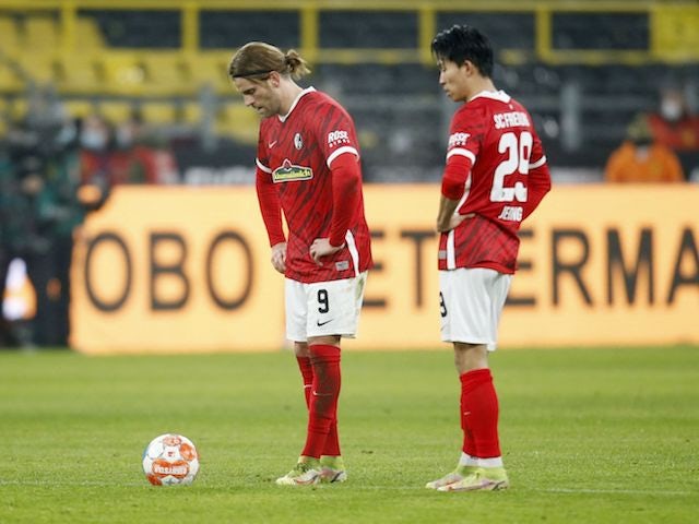 Freiburg's Lucas Holer and Jeong Woo-yeong look dejected after Borussia Dortmund's Erling Braut Haaland scored their third goal  on January 14, 2022
