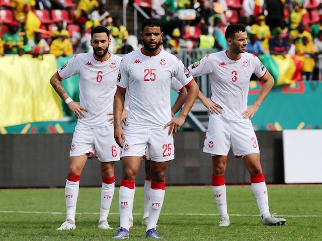 Tunisia's Anis Ben Slimane, Dylan Bronn and Montassar Talbi wait as VAR reviews their penalty on January 12, 2022