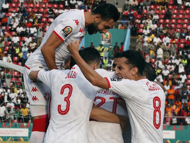 Tunisia's Hamza Mathlouthi celebrates scoring their first goal with teammates on January 16, 2022