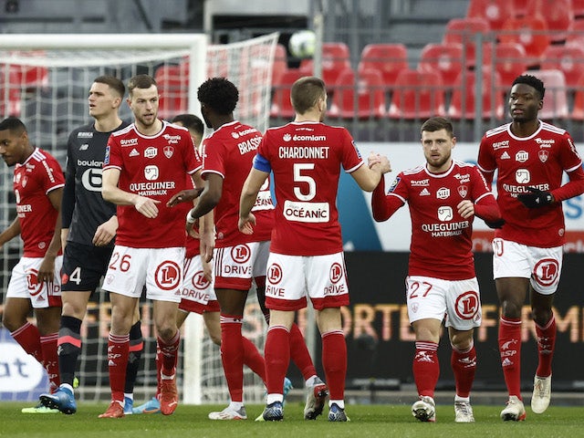 Brest players celebrate after Lille's Tiago Djalo scores an own goal and Brest's first on January 22, 2022