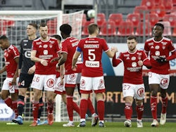 Brest players celebrate after Lille's Tiago Djalo scores an own goal and Brest's first on January 22, 2022