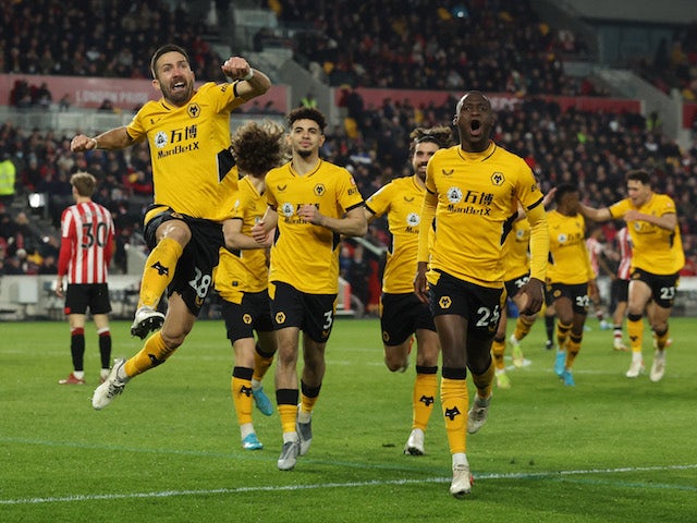 Wolverhampton Wanderers' Joao Moutinho celebrates scoring their first goal with Tote Gomes on January 22, 2022