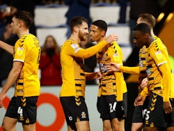 Cambridge United's Harvey Knibbs celebrates scoring their first goal with teammates on January 18, 2022