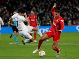 Sevilla's Diego Carlos in action with Real Madrid's Marco Asensio on November 28, 2021