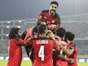 Egypt's Mohamed Abdelmonem celebrates scoring their first goal with teammates on January 19, 2022
