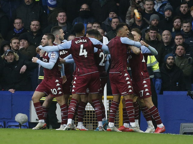 Aston Villa's Emiliano Buendia celebrates scoring their first goal with teammates as a bottle is thrown from the crowd on January 22, 2022