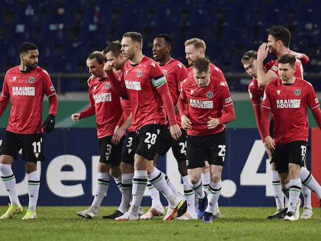 Hannover 96's Maximilian Beier celebrates scoring their first goal with Linton Maina, Marcel Franke, Dominik Kaiser, Jannik Dehm and teammates on January 19, 2022