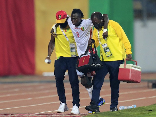 Guinea's Issiaga Sylla is helped off the pitch after sustaining an injury on January 18, 2022
