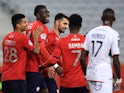Lille's Amadou Onana, Reinildo Mandava and Jonathan Bamba celebrate after Lorient's Moritz Jenz scores an own goal on January 19, 2022