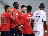 Lille's Amadou Onana, Reinildo Mandava and Jonathan Bamba celebrate after Lorient's Moritz Jenz scores an own goal on January 19, 2022