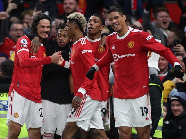 Manchester United's Marcus Rashford celebrates scoring their first goal with Edinson Cavani, Fred, Anthony Martial and Raphael Varane on January 22, 2022