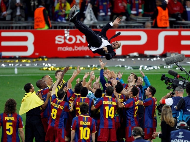 Barcelona's manager Pep Guardiola is thrown in the air by his players after their Champions League final win against Manchester United on May 28, 2011