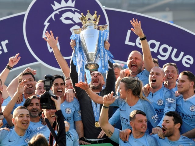 Manchester City manager Pep Guardiola lifts the Premier League trophy on May 12, 2019 