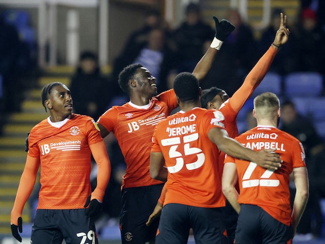 Luton Town players celebrate after Reading's Tom Holmes scores an own goal on January 19, 2022