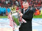 Manchester United manager Sir Alex Ferguson celebrates with the Premier League trophy on May 12, 2013