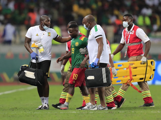Cameroon's Collins Fai walks off the pitch after receiving medical attention on January 29, 2022