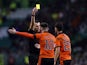 Dundee United's Calum Butcher is shown a yellow card by the referee on January 29, 2022