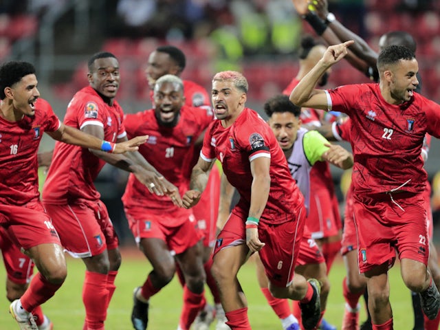 Equatorial Guinea's Saul Coco, Iban Salvador and Pablo Ganet celebrate after winning the penalty shoot out on January 26, 2022