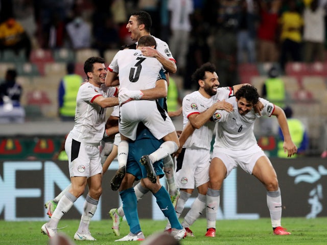 Egypt's Mohamed Salah celebrates with teammates after winning the penalty shootout on January 26, 2022
