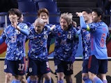 Japan's Junya Ito celebrates scoring their second goal with teammates on January 27, 2022