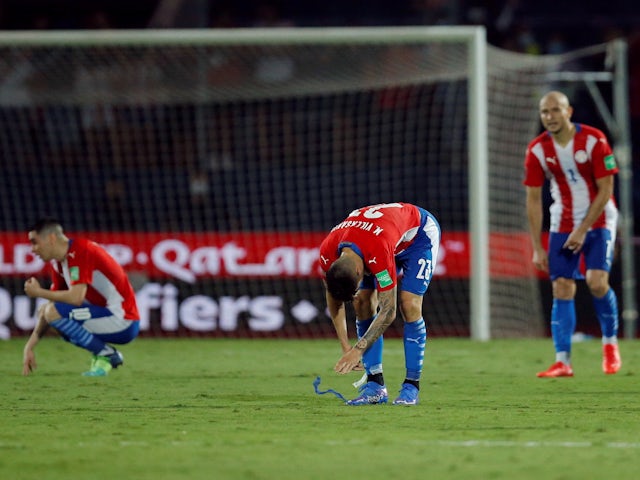 Paraguay's Mathias Villasanti and teammates look dejected after the match on January 27, 2022
