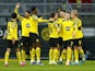 Borussia Dortmund players celebrate after Bayer Leverkusen's Jeremie Frimpong scores an own goal and Borussia Dortmund's first on February 6, 2022
