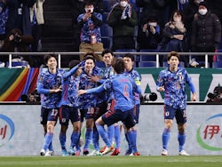Japan's Takumi Minamino celebrates scoring their first goal with teammates on February 1, 2022