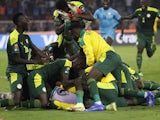 Senegal players celebrate winning the penalty shoot out on February 6, 2022