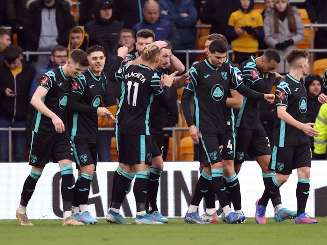 Norwich City's Kenny McLean celebrates scoring their first goal with teammates on February 5, 2022