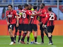 AC Milan's Rafael Leao celebrates scoring their first goal with Mike Maignan and teammates on February 13, 2022