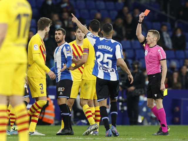 Barcelona's Gerard Pique and Espanyol's Nico Melamed are shown a red card by referee Alejandro Hernandez on February 13, 2022