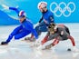 Yuri Confortola (ITA) skates beside Charles Hamelin (CAN) as Farrell Treacy (GBR) trails behind at the Beijing 2022 Winter Olympics on February 9, 2022