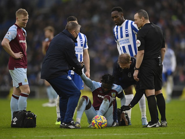 Burnley's Maxwel Cornet is helped up after sustaining an injury on February 19, 2022