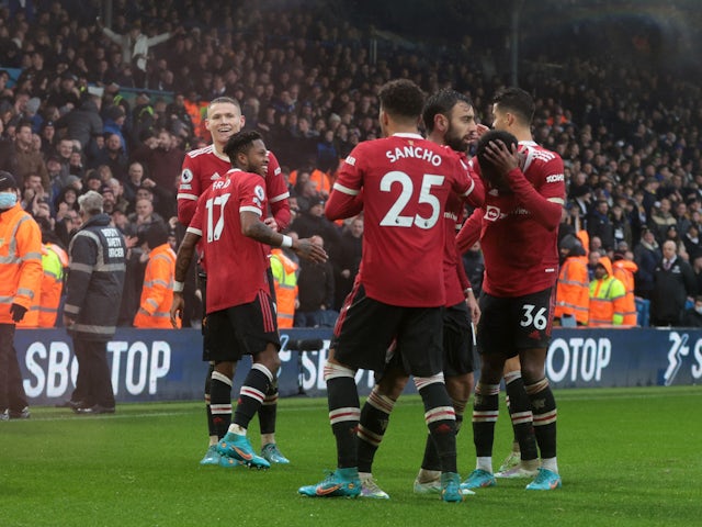 Manchester United's Anthony Elanga reacts after being struck in the head by an object as they celebrate their third goal scored by Fred on February 20, 2022
