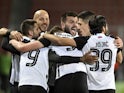 Partizan Belgrade's Queensy Menig celebrates scoring their first goal with teammates on February 17, 2022