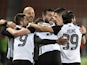 Partizan Belgrade's Queensy Menig celebrates scoring their first goal with teammates on February 17, 2022