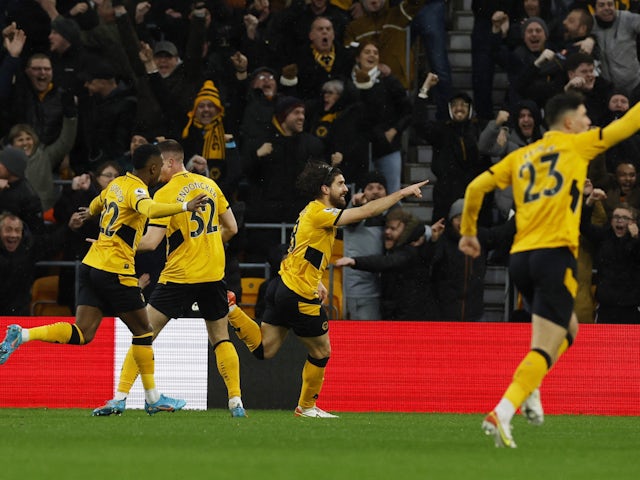 Wolverhampton Wanderers' Ruben Neves celebrates scoring their first goal with teammates on February 20, 2022