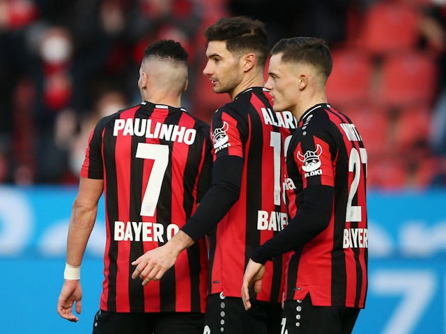 Bayer Leverkusen's Lucas Alario celebrates scoring their first goal with Paulinho and Florian Wirtz on February 26, 2022