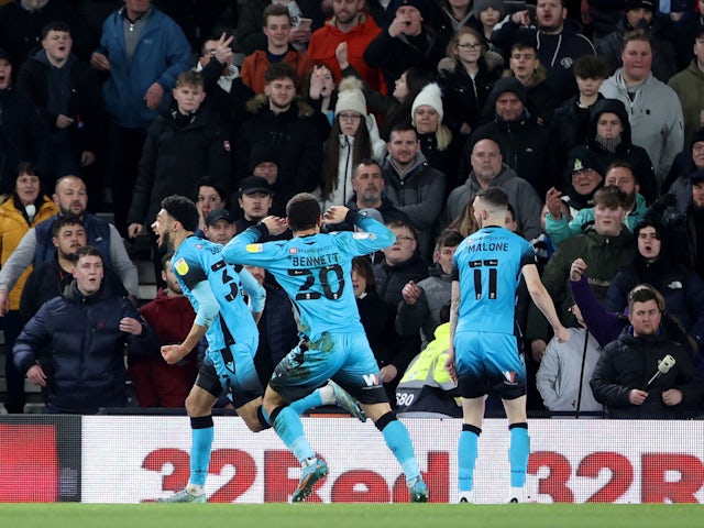 Millwall's Tyler Burey celebrates with his teammates after scoring his second goal on 23 February 2022
