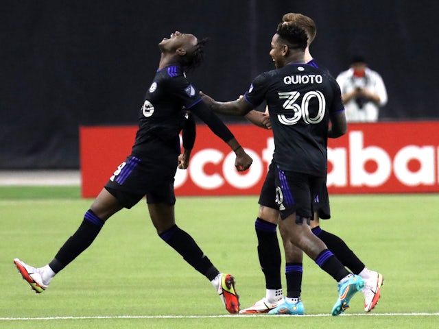 CF Montreal midfielder Ismael Kone (28) celebrates his goal against Santos Laguna with teammates forward Romell Quioto (30) and defender Joel Waterman (16) during the second half at Olympic Stadium on February 24, 2022