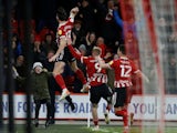 Sheffield United's Ben Davies celebrates scoring their first goal with teammates on February 23, 2022