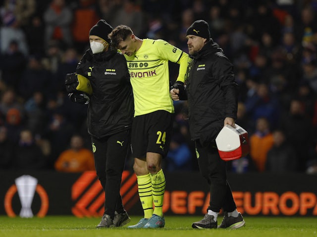 Borussia Dortmund's Thomas Meunier receives medical attention on February 24, 2022