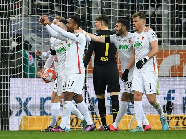 Augsburg's Noah Sarenren Bazee celebrates scoring their first goal with teammates on February 27, 2022