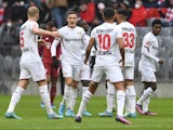 Bayer Leverkusen's Florian Wirtz, Kerem Demirbay, Piero Hincapie and Mitchel Bakker celebrate after Bayern Munich's Thomas Muller scores an own goal on March 5, 2022